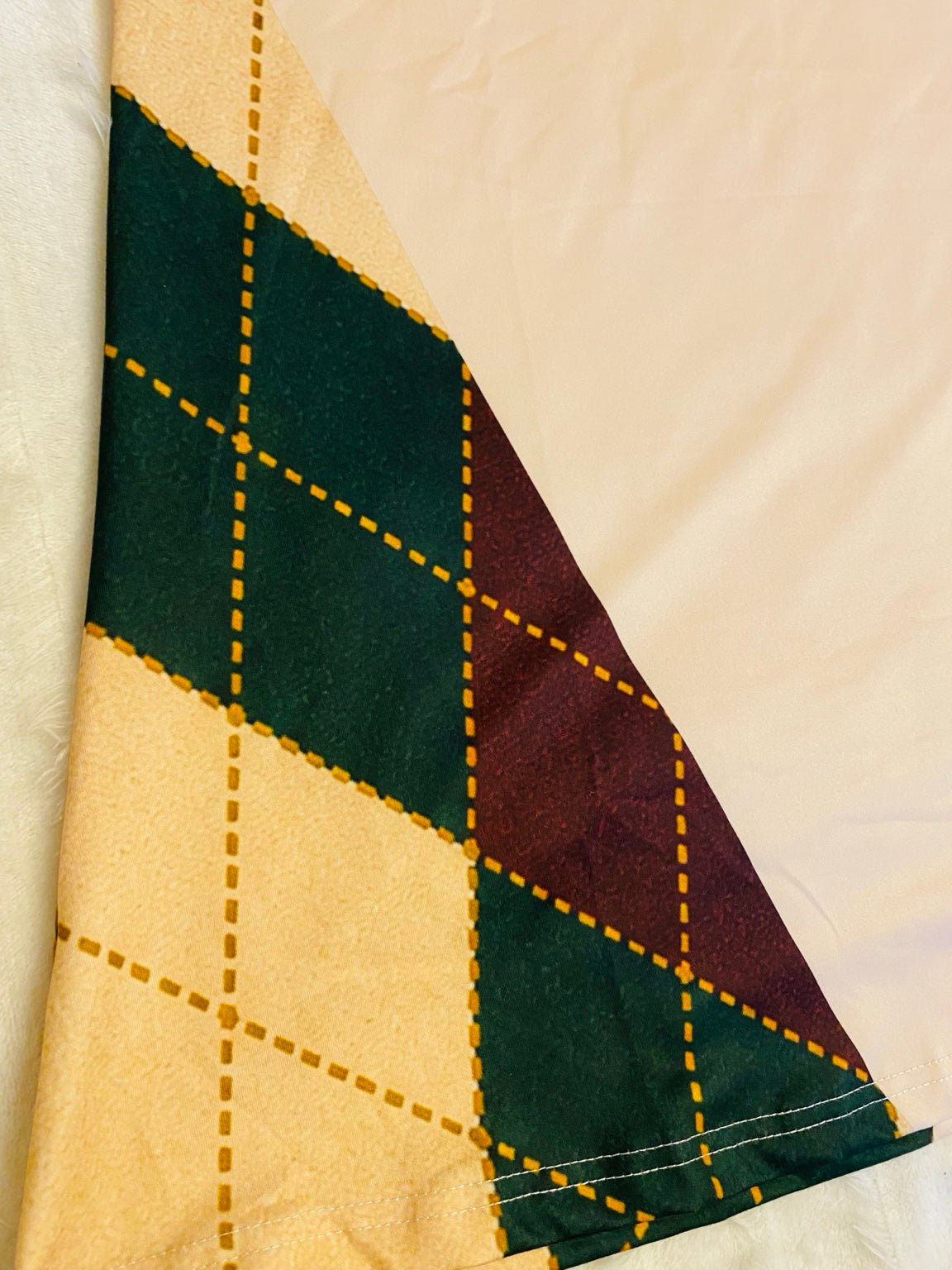 Burgundy forest green and cream argyle side panel and stitched hem of the Jinglemoo