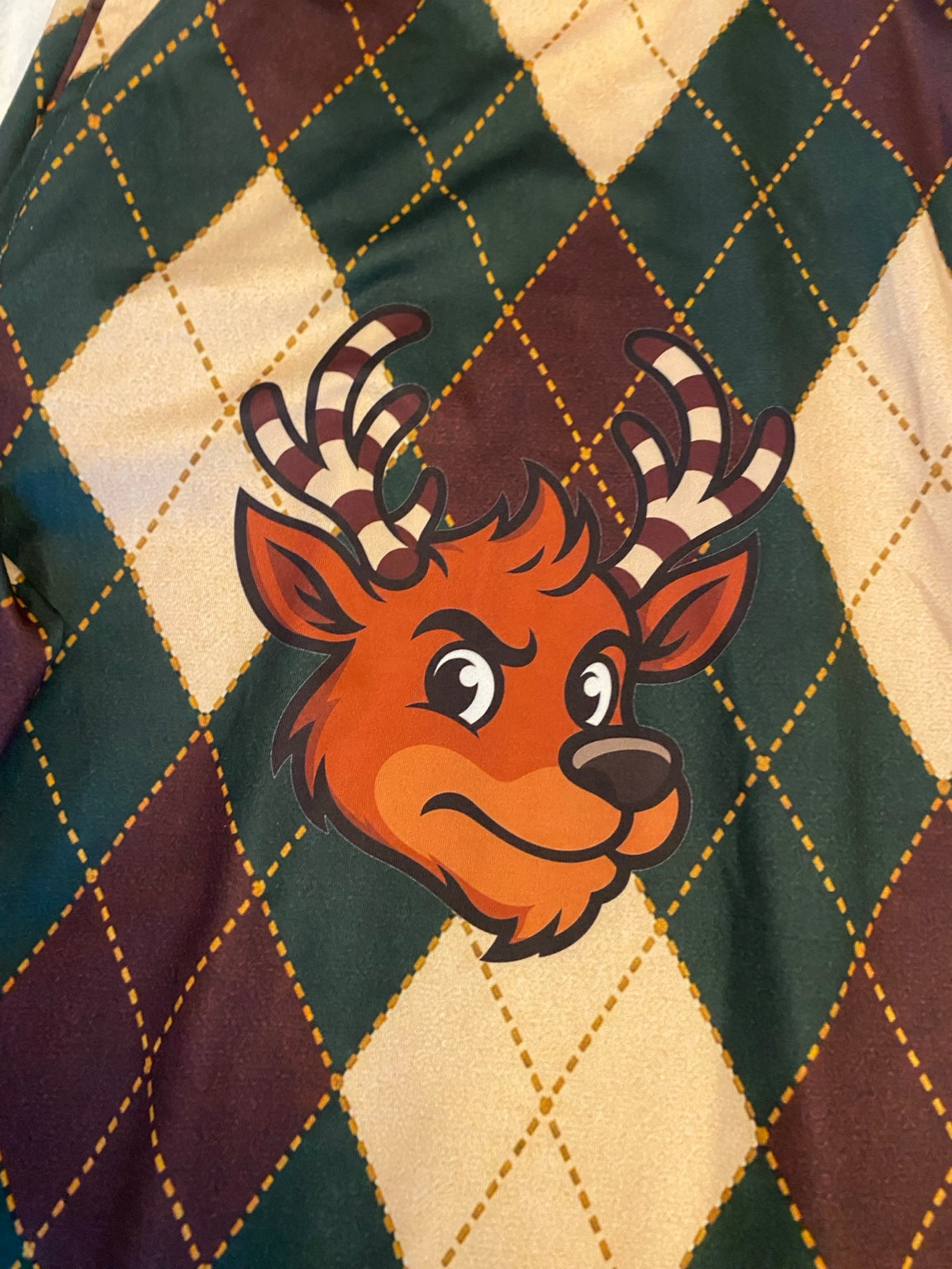 Nick the reindeer with candy-cane antlers printed on SU Argyle pajama pants